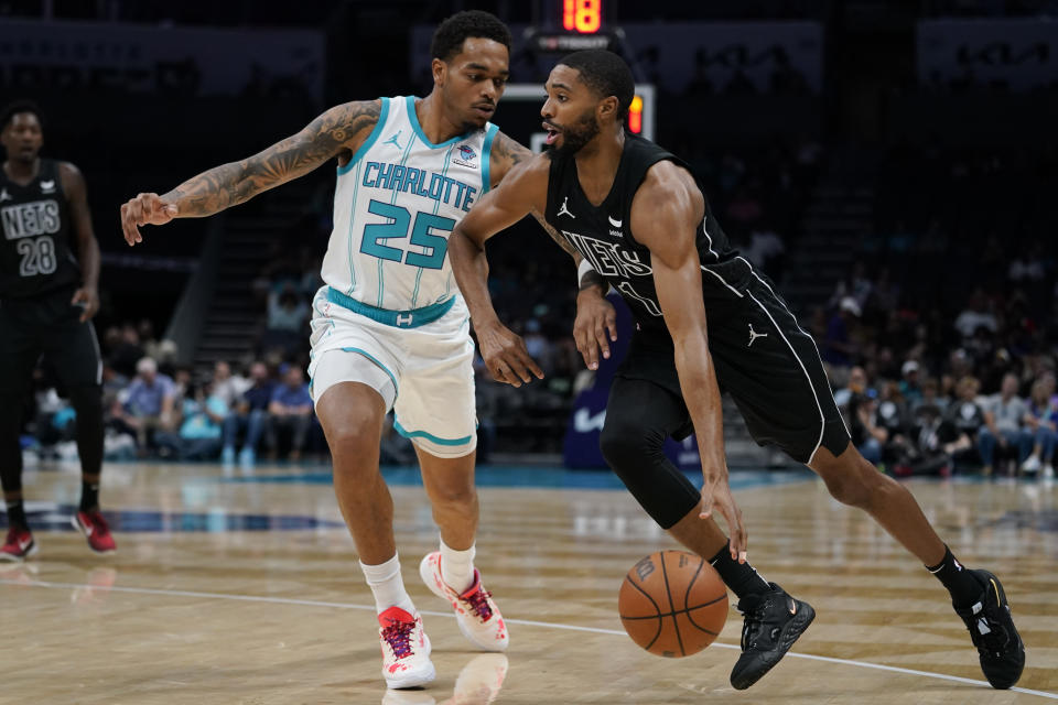 Charlotte Hornets forward P.J. Washington, left, defends against Brooklyn Nets forward Mikal Bridges in the first half of an NBA basketball game, Monday, Oct. 30, 2023, in Charlotte, N.C. (AP Photo/Erik Verduzco)