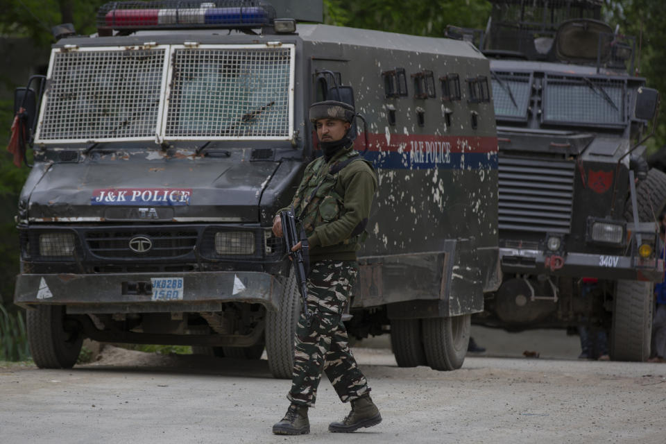 An Indian paramilitary soldier stands guard as police and army soldiers launch an operation in Awantipora area, south of Srinagar, Indian controlled Kashmir, Wednesday, May 6, 2020. Government forces killed a top rebel commander and his aide in Indian-controlled Kashmir on Wednesday and shut down cellphone and mobile internet services during subsequent anti-India protests, officials, and residents said. (AP Photo/ Dar Yasin)
