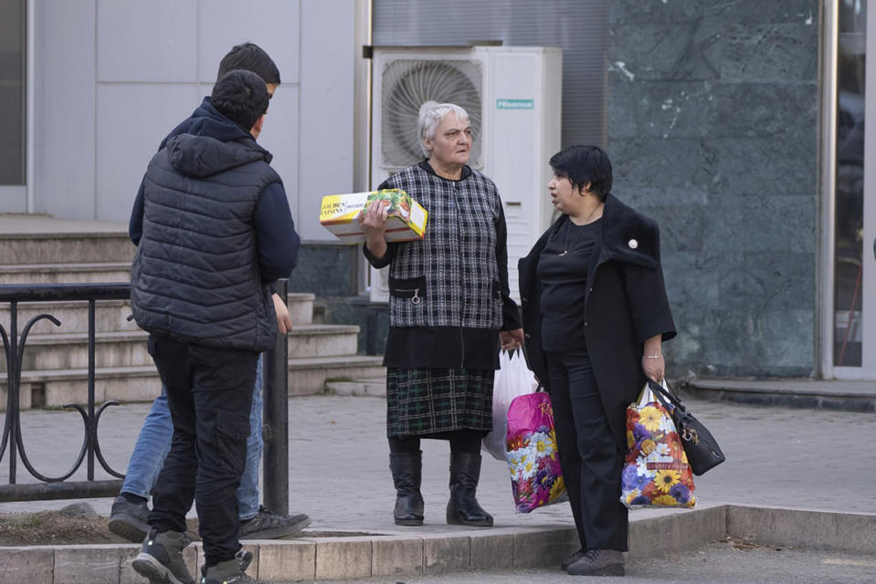 Local residents are gather at a food store in Stepanakert, the capital of the separatist region of Nagorno-Karabakh, also known as Artsakh, on Friday, Jan. 20, 2023. Protesters claiming to be ecological activists have blocked the only road leading from Armenia to Nagorno-Karabakh for more than a month, leading to increasing food shortages. Local authorities have called for a humanitarian airlift for critical supplies, but Azerbaijan has not authorized the region's airport to operate. (Edgar Harutyunyan/PAN Photo via AP)