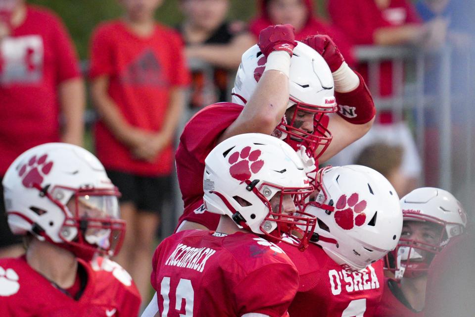 Beechwood's Mitchell Berger, center, celebrates with teammates after scoring a touchdown during a KHSAA high school football game against the Simon Kenton Pioneers at Beechwood High School Friday, Sept. 9, 2022, in Fort Mitchell, Ky.