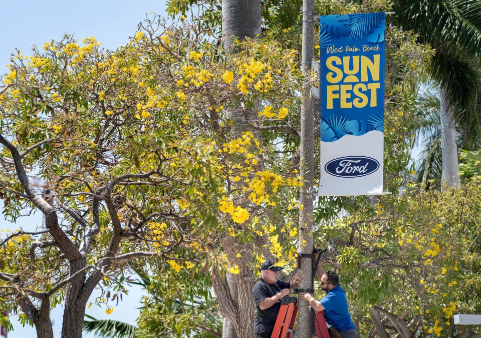 Karl Laudenslager, left, and Andrew Ello prepare for Sunfest in West Palm Beach, Florida on May 4, 2023. 