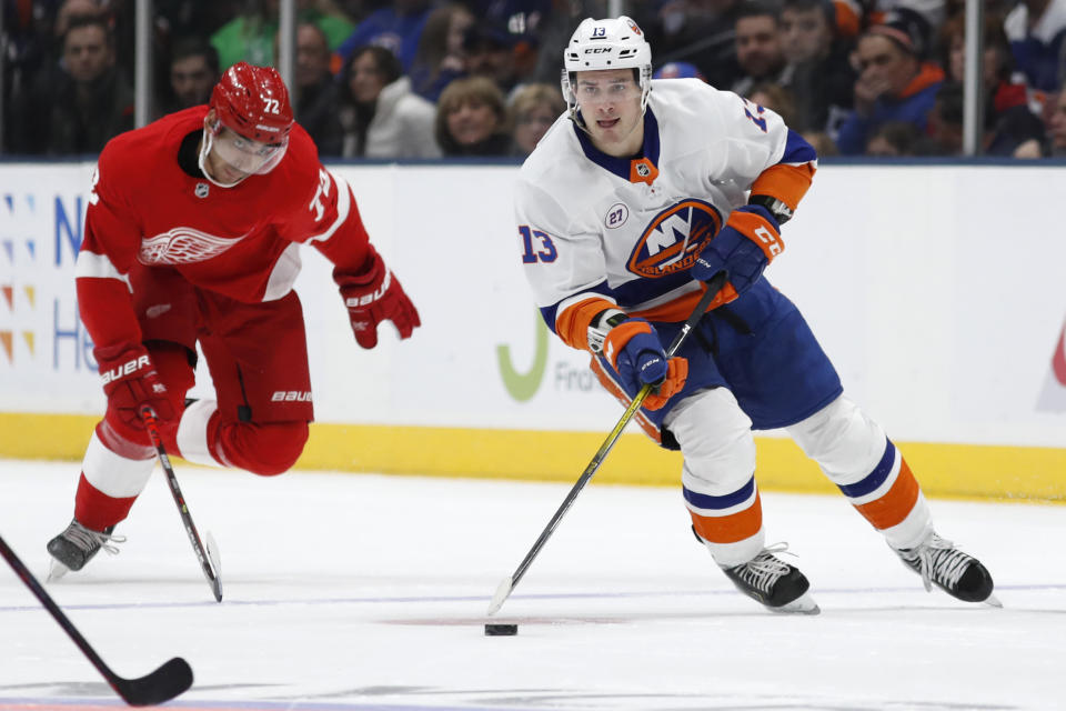 New York Islanders center Mathew Barzal (13) skates with the puck as Detroit Red Wings left wing Andreas Athanasiou (72) pursues during the second period of an NHL hockey game Friday, Feb. 21, 2020, in Uniondale, N.Y. (AP Photo/Kathy Willens)