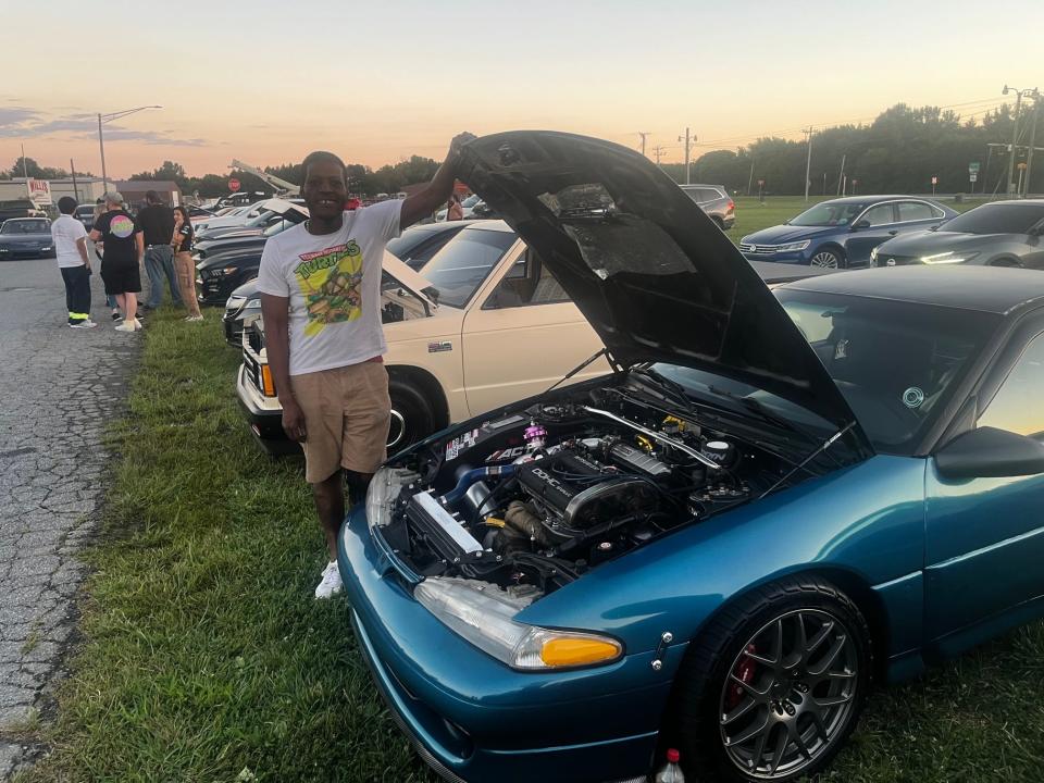 Donell Booker, a mechanical engineer from Newark, by the 500-horsepower Eagle Talon he built at a car meet at Smyrna's Pit Daddy's BBQ on August 31, 2023.
