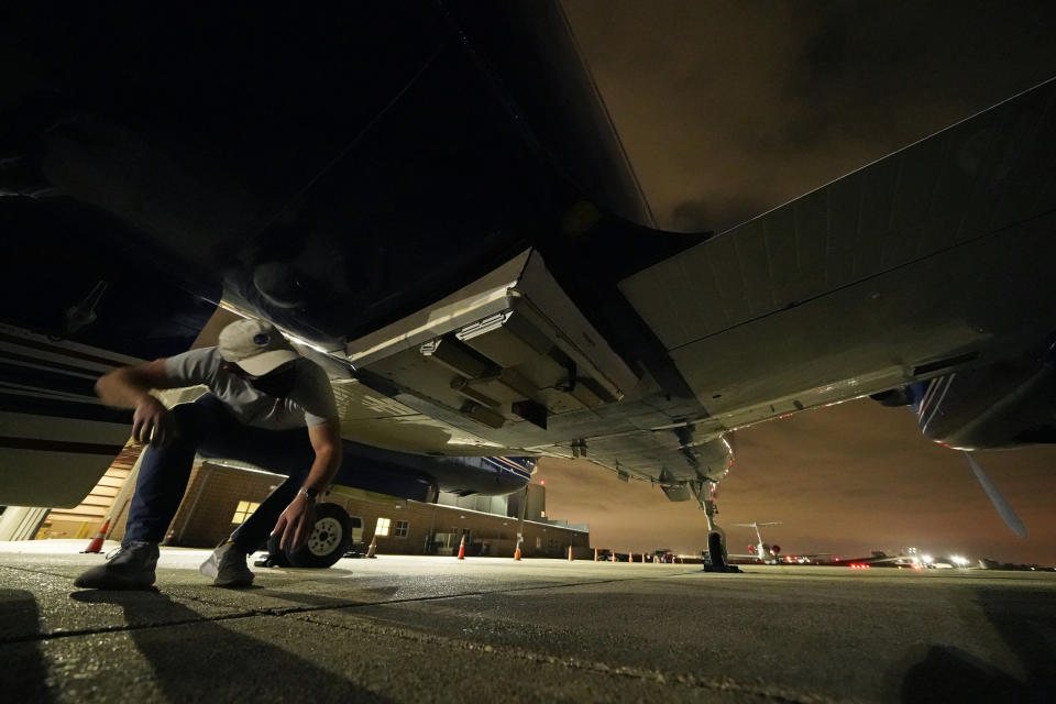 Jack Bush, electrical engineer and radar operator for the NASA Jet Propulsion Laboratory, checks the antennas of a K-band phenomenology airborne radar (Air SWOT), underneath a King Air twin engine airplane, before one of many flights over the Atchafalaya River delta to measure surface water velocity, at New Orleans Lakefront Airport, in New Orleans on Wednesday, April 7, 2021. (AP Photo/Gerald Herbert)