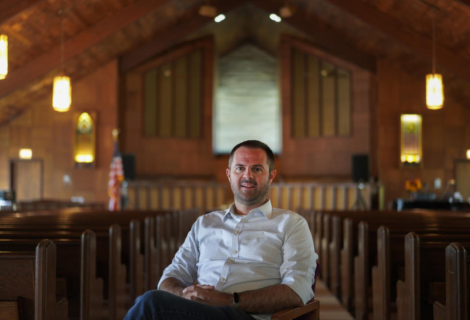 Pastor Ryan Burge, an associate professor of political science at Eastern Illinois University and author of "The Nones," a book on the growing number of religiously unaffiliated Americans, poses for a portrait at at First Baptist Church in Mt. Vernon, Ill., Sunday, Sept. 10, 2023. (AP Photo/Jessie Wardarski)