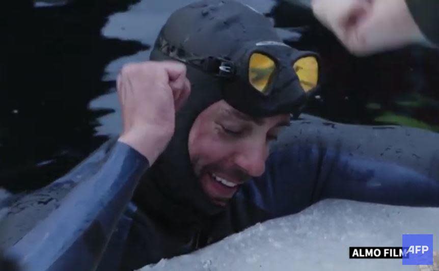 French freediver Arthur Guerin-Boeri sets the world record for the longest-distance swim under a sheet of ice with a single breath, swimming some 394 feet in Finland's Lake Sonnanen, north of Helsinki. / Credit: AFP/Almo Films