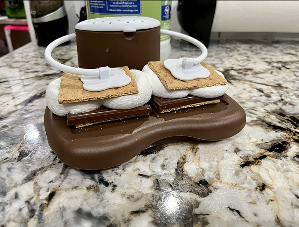 reviewer image of the s'mores maker holding two s'mores