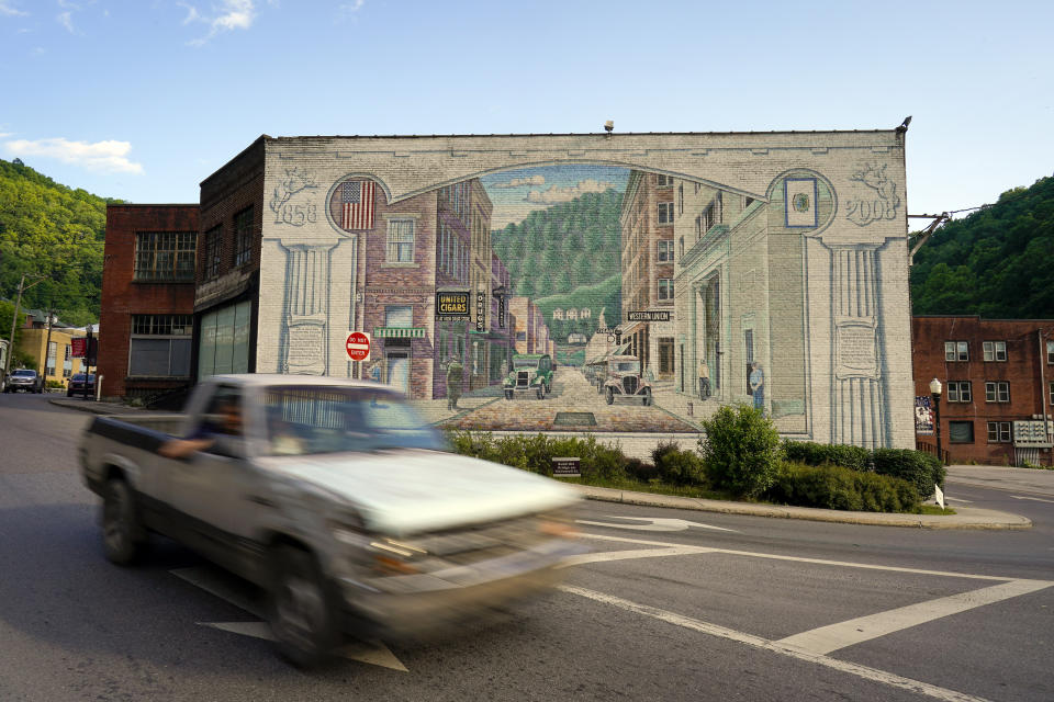 A truck passes a mural the depicting downtown area of Welch, W.Va., Thursday, June 1, 2023. In March, the weekly publication in McDowell County one of the poorest counties America became another one of the quarter of all U.S. newspapers that have shuttered since 2005, a crisis Nester called "terrifying for democracy" and one that disproportionately impacts rural America. (AP Photo/Chris Carlson)