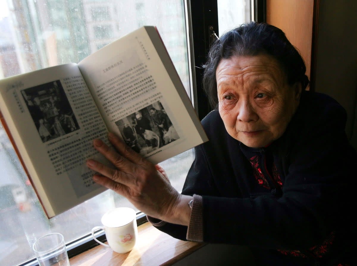 Gao Yaojie in 2007, with her book ‘Prevention of Aids and Sexually Transmitted Diseases’ (AP)