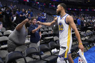 Golden State Warriors guard Stephen Curry celebrates with a fan after Game 3 against the Dallas Mavericks in the NBA basketball playoffs Western Conference finals, Sunday, May 22, 2022, in Dallas. The Warriors won 109-100. (AP Photo/Tony Gutierrez)
