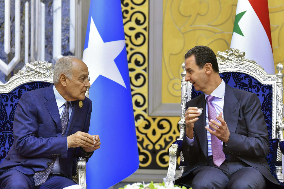 In this photo provided by Saudi Press Agency, SPA, Syrian President Bashar Assad, talks to Ahmed Aboul Gheit, Secretary-General of the Arab League, Ahmed Aboul Gheit, upon his arrival at Jeddah airport, Saudi Arabia, Thursday, May 18, 2023, ahead of the Arab summit. (Saudi Press Agency via AP)