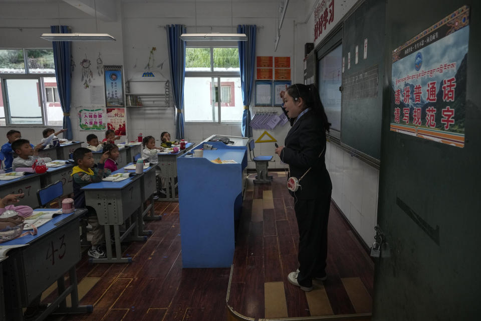 A teacher teaches alphabets in a first-grade class at the Shangri-La Key Boarding School during a media-organized tour in Dabpa county, Kardze Prefecture, Sichuan province, China on Sept. 5, 2023. (AP Photo/Andy Wong)