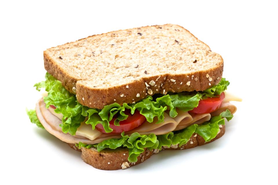 Pictured is a turkey sandwich with swiss cheese, lettuce and tomato.