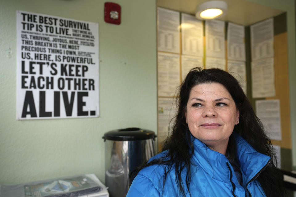 Windy Click, director of community engagement, looks out toward people on the street at the Hospitality House in San Francisco, Wednesday, Feb. 7, 2024. A measure aimed at transforming how California spends money on mental health will go before voters in March as the state continues to grapple with an unabated homelessness crisis. Hospitality House's programs are among a slew of prevention services that would face significant budget cuts if Proposition 1 passes. (AP Photo/Eric Risberg)