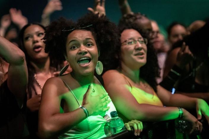 Fans sing, shout and dance near the stage.