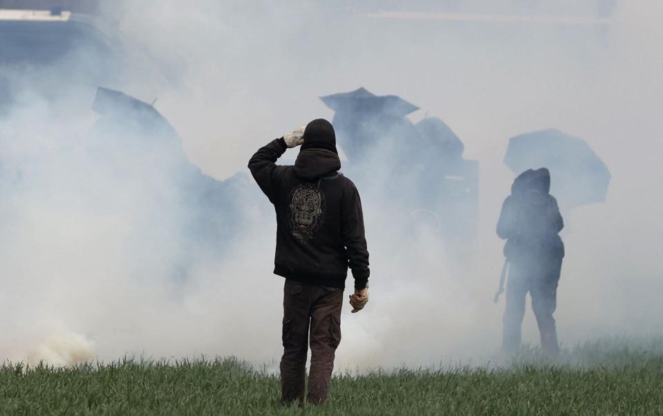 Protesters, surrounded by tear gas, clash with riot mobile gendarmes in Sainte-Soline - AFP