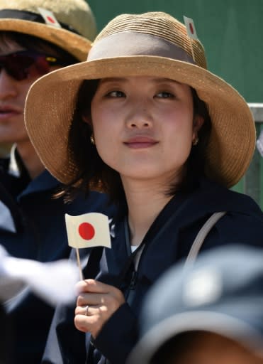 A Japanese fan watches Kei Nishikori in action at the All England Club