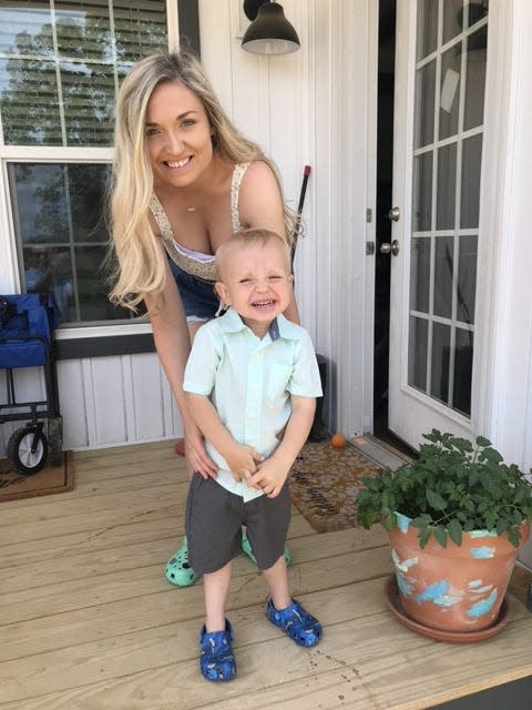 Chesney Cross, with her son Cash, outside their new manufactured home in Sevierville, Tennessee.