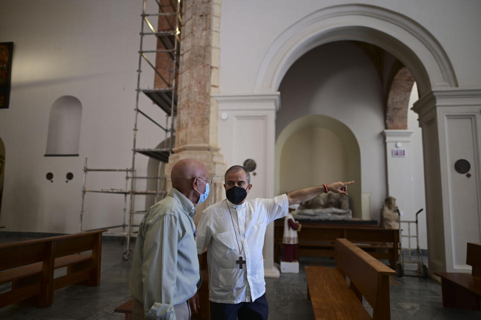 Monsignor Roberto González, the archbishop of San Juan, points as he and businessman Ricardo Gonzalez stand inside the San Jose Church after its reconstruction in San Juan, Puerto Rico, Tuesday, March 9, 2021. The $11 million restorations became a personal project for González that took nearly two decades to complete. (AP Photo/Carlos Giusti)