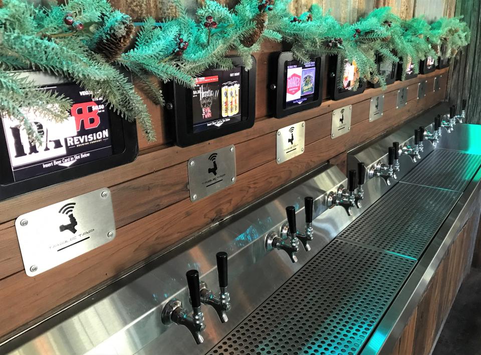 This Friday, Dec. 17, 2021 network photo shows an example of a beer wall, where customers can pour their own drinks, at a California restaurant.