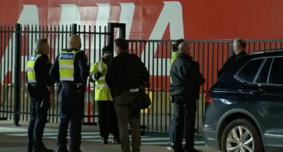 Group of police in front of cruise ship during search for man's body. 