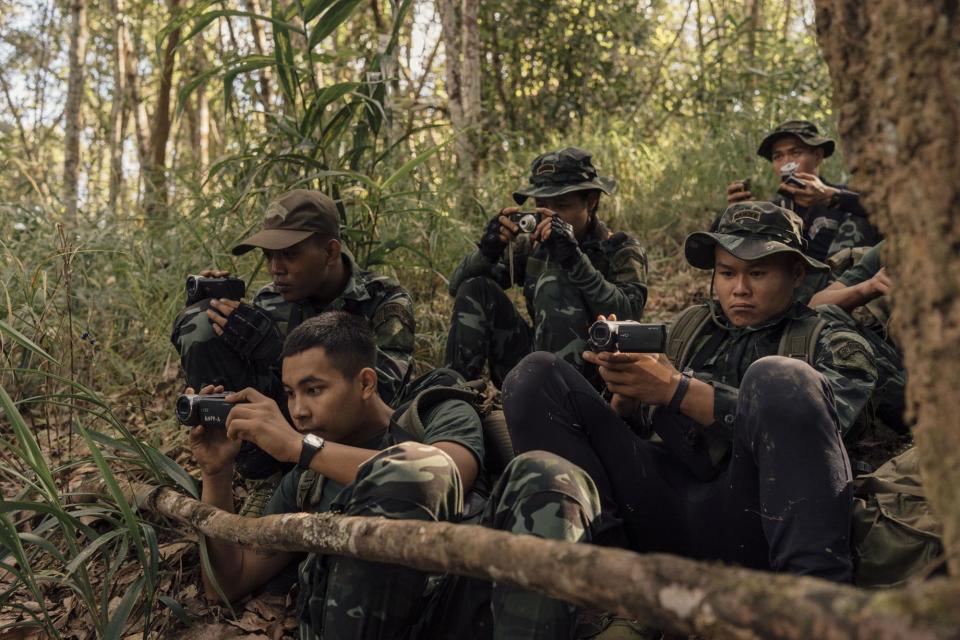 FBR trainees video record activity at a Burma Army encampment on an opposing ridge.