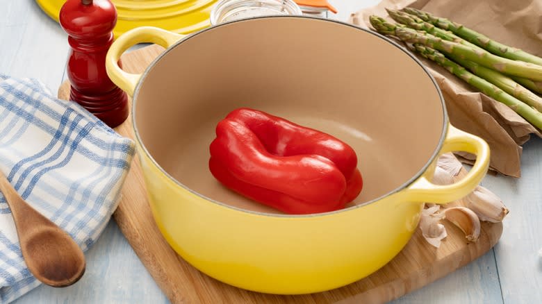 French oven with raw bell pepper inside