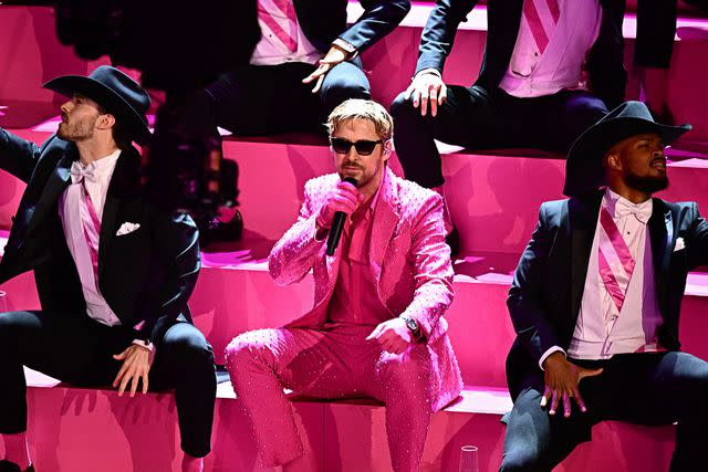 <p>PATRICK T. FALLON/AFP via Getty</p> Ryan Gosling performing at the 2024 Oscars.