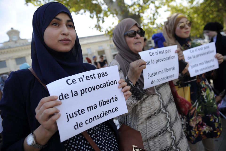 Women hold signs reading, "It is not a provocation, just my freedom of conscience" during a headscarf march against Islamophobia in Avignon, southern France.