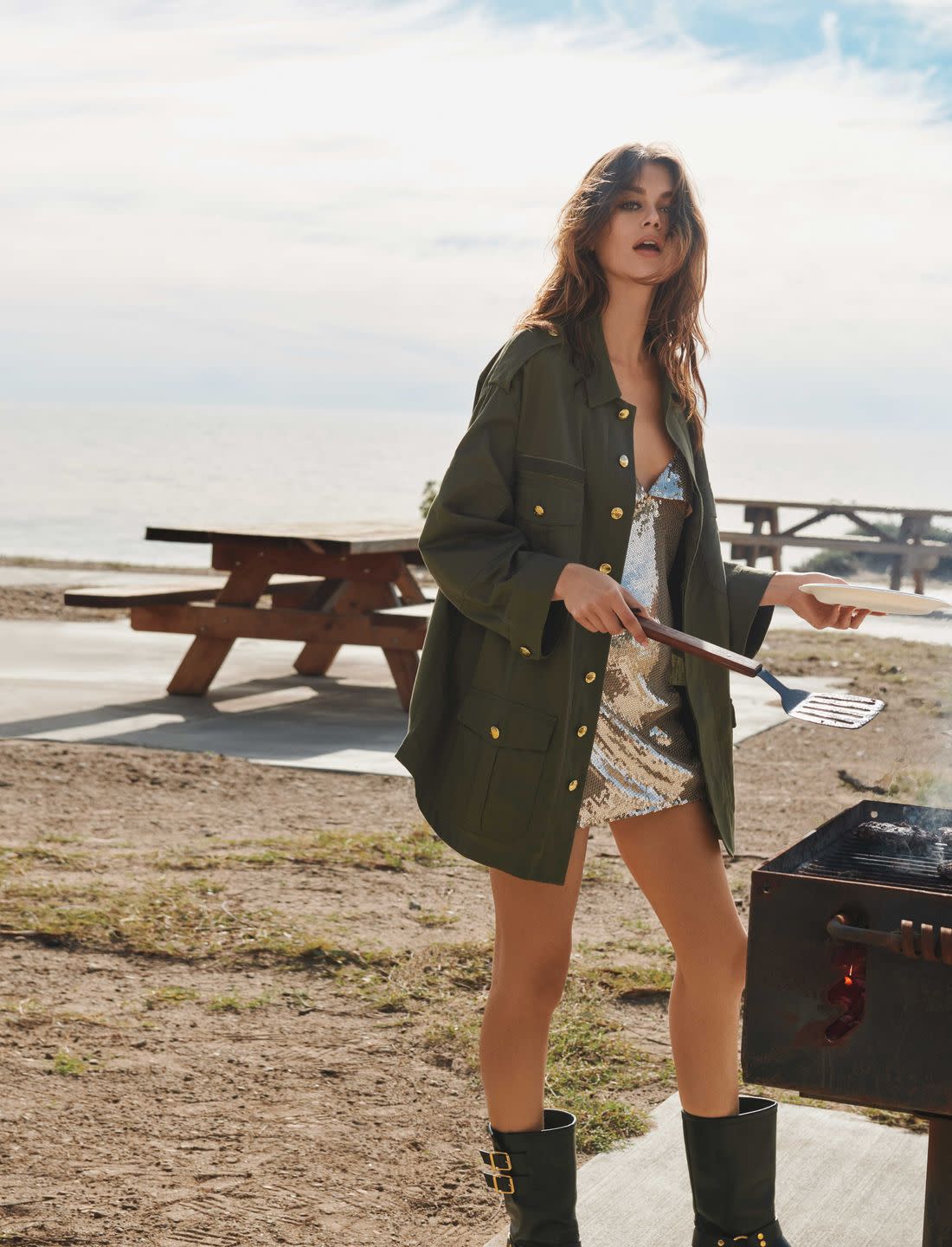 a white brunette woman grilling on the beach