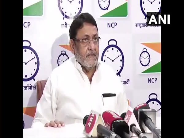 NCP spokesperson Nawab Malik talking to reporters on Tuesday. (Photo/ANI)