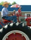 <p>Alan Dingfelder, of North East Township, and his dog Annie, ride in the Millcreek Township Fourth of July parade, near Erie, Pa., on Dingfelder’s 1936 Farmall tractor, Tuesday, July 4, 2017. (Photo: Jack Hanrahan/Erie Times-News via AP) </p>