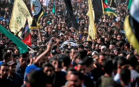 Mourners chant slogans as they carry the body of Palestinian Islamic Jihad senior leader Baha Abu Al-Ata - Credit: Photo by MAHMUD HAMS/AFP via Getty Images