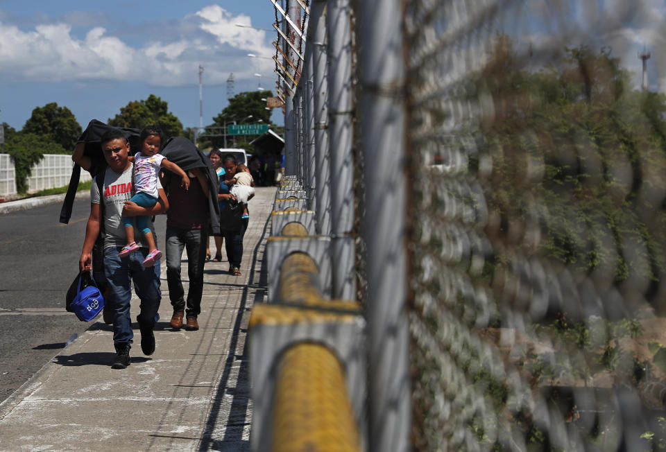 A Honduran migrant family returns to Guatemala on a bridge over the Suchiate River, near Ciudad Hidalgo, Mexico, Thursday, June 6, 2019. Some migrants are returning to Guatemala voluntarily, apparently discouraged by the stepped-up Mexican effort to detain them. (AP Photo/Marco Ugarte)