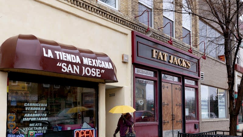 A woman walks past La Tienda Mexicana in Whitewater, Wis., on Wednesday, April 3, 2024. Whitewater has seen a wave of migration from the southern border of Mexico. City officials estimate that there are about 800 to 1,000 migrants from Nicaragua and Venezuela living in Whitewater.