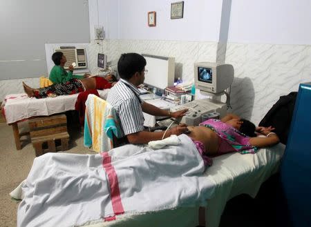 Indian gynaecologists conduct ultrasound examinations on pregnant women at a government-run hospital in the northeastern Indian city of Agartala March 17, 2015. REUTERS/Jayanta Dey