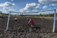 Players of Zero Erectus and Korpiklaani play during a game at the Swamp Soccer World Championships tournament in Hyrynsalmi, Finland July 13, 2018. Picture taken July 13, 2018. Lehtikuva/Kimmo Rauatmaa/via REUTERS