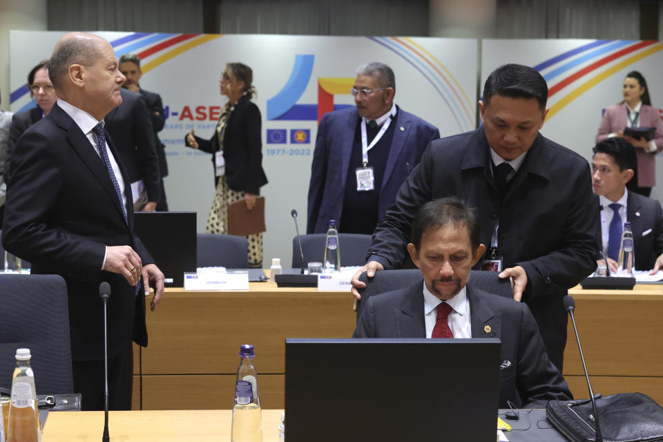 Germany's Chancellor Olaf Scholz, left, and the Sultan of Brunei Hassanal Bolkiah, second right, attend a round table meeting during the EU-ASEAN summit in Brussels, Wednesday, Dec. 14, 2022. EU and ASEAN leaders meet in Brussels for a one day summit to discuss the EU-ASEAN strategic partnership, trade relations and various international topics. (AP Photo/Olivier Matthys, Pool)