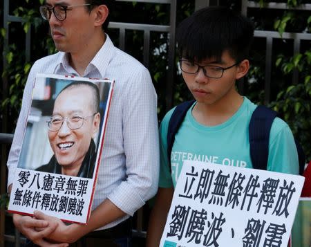 Student leader Joshua Wong (R) attends a protest demanding the release of Chinese Nobel rights activist Liu Xiaobo outside China's Liaison Office in Hong Kong, China June 27, 2017. REUTERS/Bobby Yip