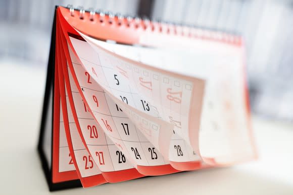 A calendar is shown with pages being flipped.