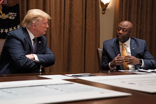 Evan Vucci/AP/Shutterstock Then-President Donald Trump meets with Sen. Tim Scott in May 2020