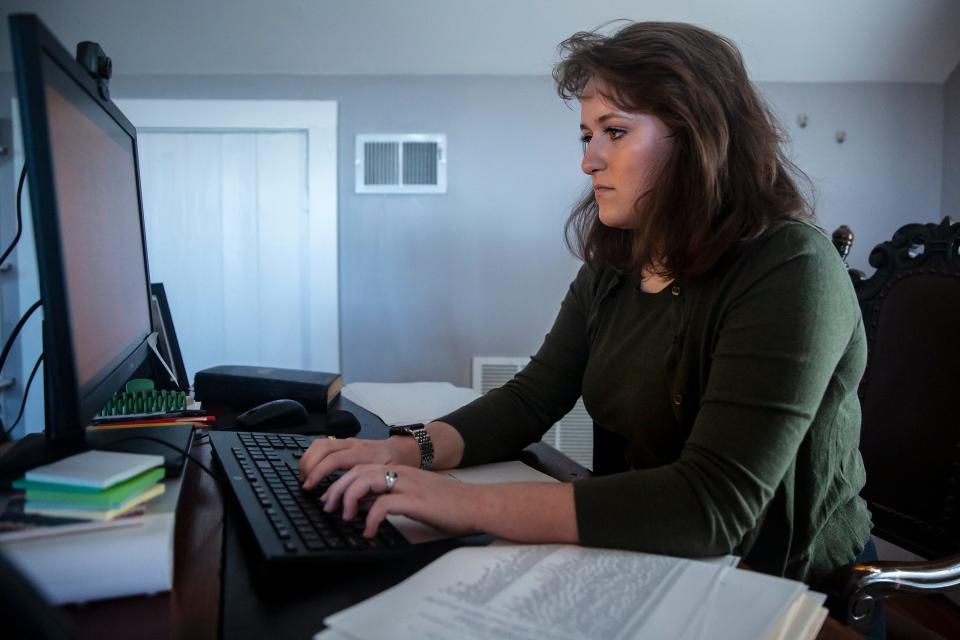 George S. Robb Centre Associate Director Ashlyn Weber works at her desk on World War I valor medal reviews on Oct. 8, 2021, at Park University, in Parkville, Missouri.