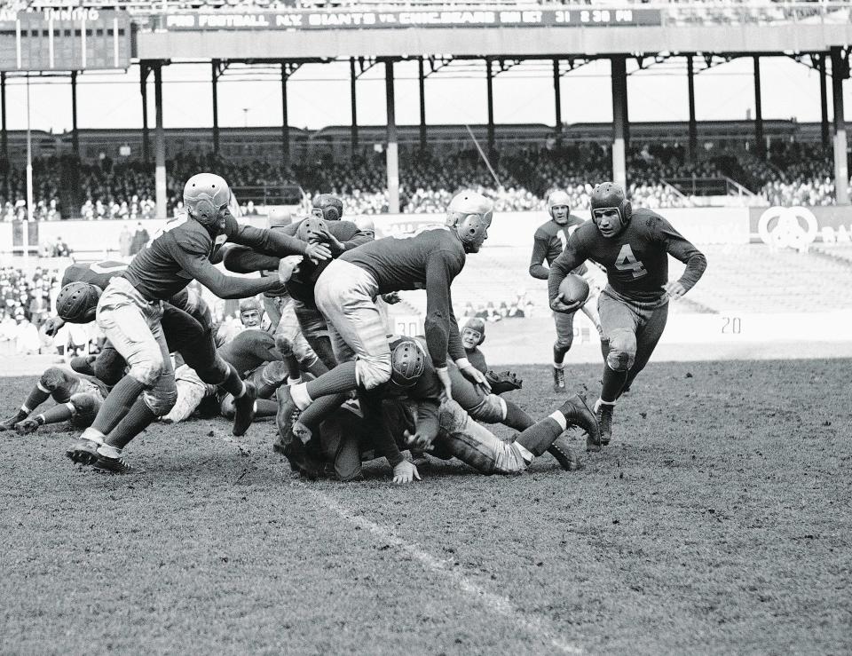 New York Giants halfback Tuffy Leemans breaks way for a four yard gain against the Brooklyn Dodgers in game at the Polo Grounds on Oct. 24, 1937 in New York.