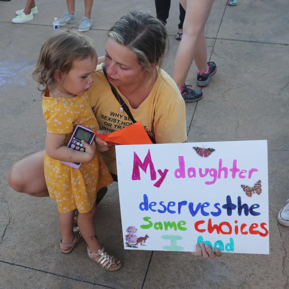 Jeanna Miller of Akron and her daughter Rory, 2, participate in the Rally for Reproductive Justice at the Cuyahoga Falls Pavilion and Amphitheater on Tuesday.