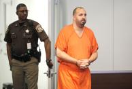 Craig Stephen Hicks, 46, is led into the Durham County District courtroom for a hearing to determine whether he will face the death penalty for the shooting deaths of three neighbors, in Durham, North Carolina, April 6, 2015. A North Carolina judge ruled on Monday that Hicks, accused of killing three young Muslims in February, could face the death penalty if convicted of murder. (REUTERS/Jason Miczek)