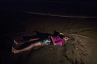 <p>The body of a Rohingya woman lays on a beach washed up after a boat sunk in rough seas off the coast of Bangladesh carrying over 100 people on September 28 close to Patuwartek, Inani beach, Bangladesh. Seventeen survivors were found along with the bodies of 15 women and children. Over 500 Rohingya refugees have fled into Bangladesh since late August during the outbreak of violence in Rakhine state as Myanmar’s de facto leader Aung San Suu Kyi downplayed the crisis during a speech in Myanmar this week faces and defended the security forces while criticism of her handling of the Rohingya crisis grows. Bangladesh’s prime minister, Sheikh Hasina, spoke at the United Nations General Assembly last week, focusing on the humanitarian challenges of hosting the minority Muslim group who currently lack food, medical services, and toilets, while new satellite images from Myanmar’s Rakhine state continue to show smoke rising from Rohingya villages. (Photograph by Paula Bronstein/Getty Images) </p>