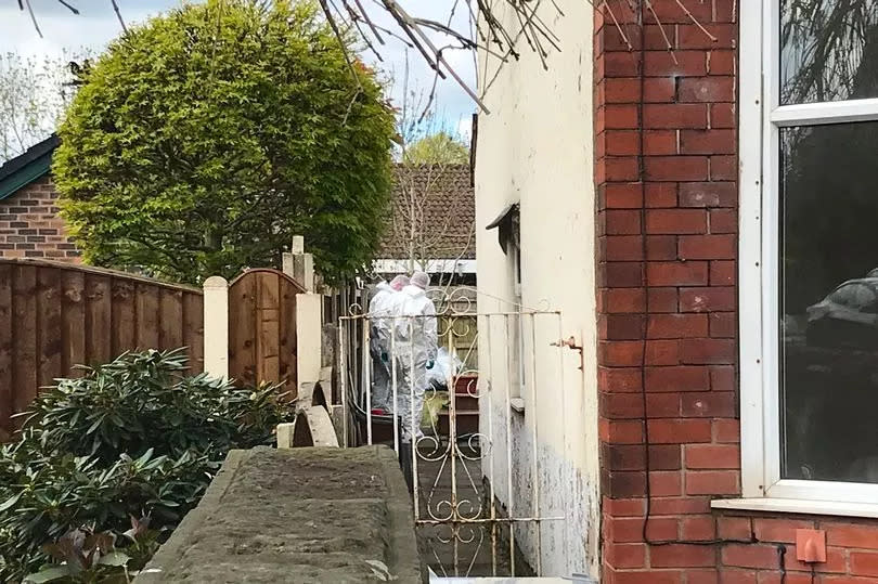 Scene of crime officers focus on the back garden of the home on Worsley Road -Credit:men