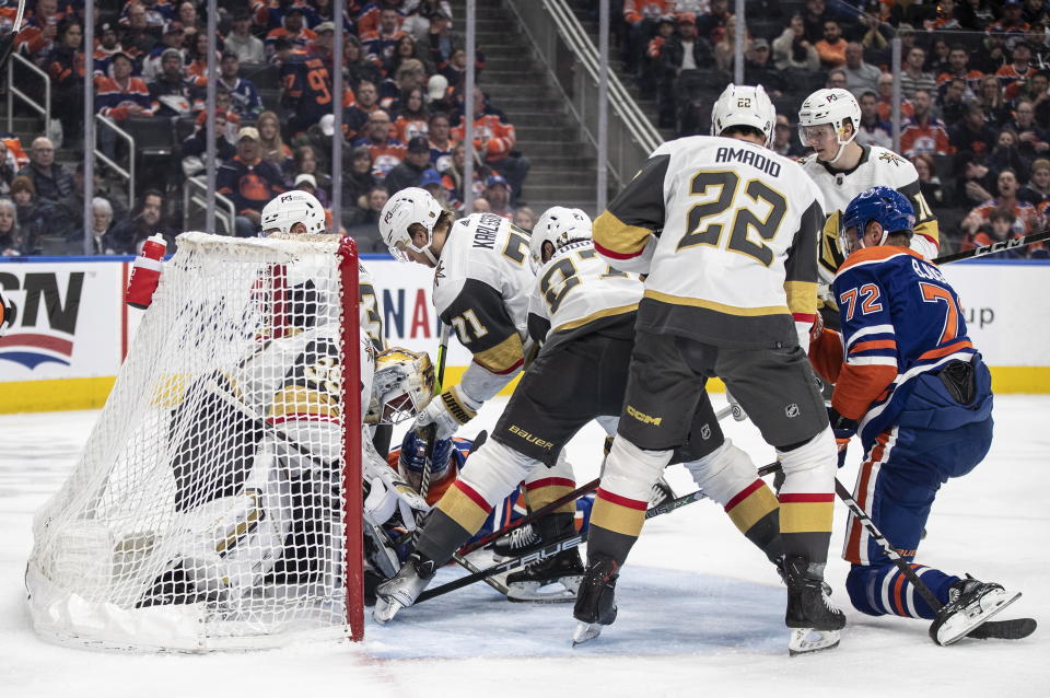 Vegas Golden Knights goalie Laurent Brossoit (39) makes a save and is pushed into the net during the second period of the team's NHL hockey game against the Edmonton Oilers on Saturday, March 25, 2023, in Edmonton, Alberta. (Jason Franson/The Canadian Press via AP)