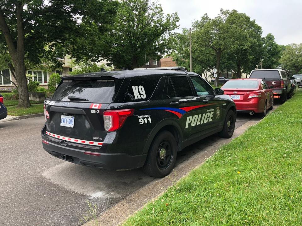 A vehicle belonging to Brantford Police's K9 unit can be seen near 200 Old Carriage Drive in Kitchener on Wednesday morning after reports of a man walking with a gun in the area.