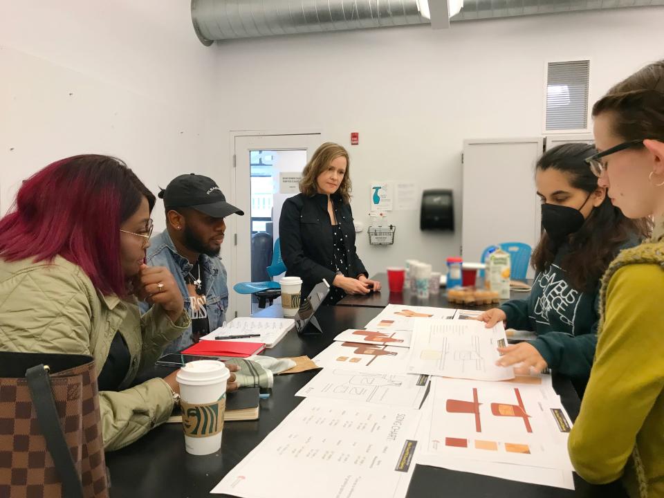 CCAD students, on the right, present designs for the Hilton Columbus Downtown uniforms to, from left, Columbus fashion designer Tracy Powell, Columbus Fashion Alliance production lead Kevin Black,  and CCAD Director of Corporate & Community Partnerships Nicole Monahan.